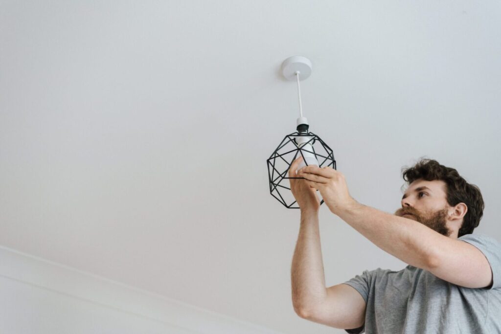 man switching lightbulb